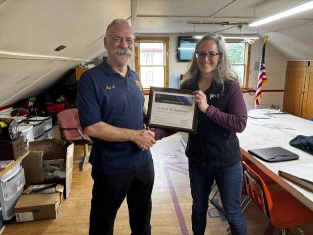 Fire Chief, Paul Doughty, accepting a plaque for the grant award.